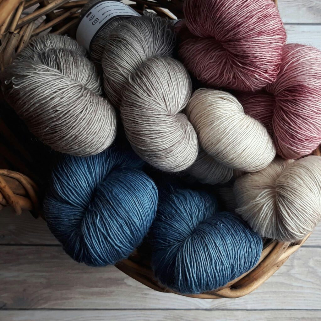 Yarn bundles of muted color in a basket